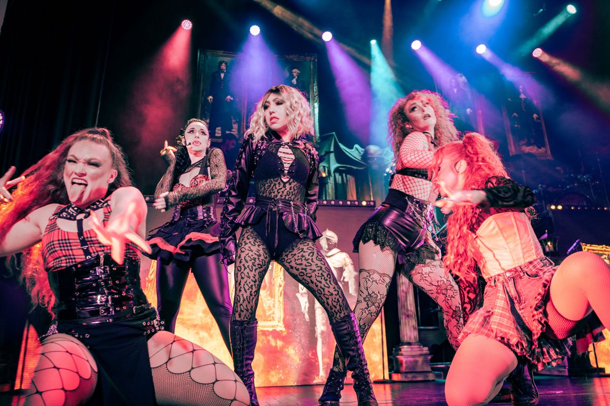 Five people dance on stage.