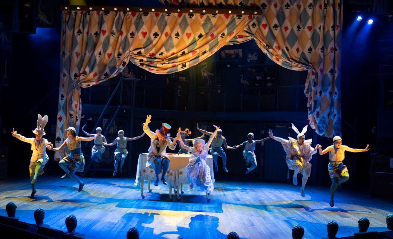 The dancers seem to be in a tea party like setting that matched the theme of Alice in Wonderland