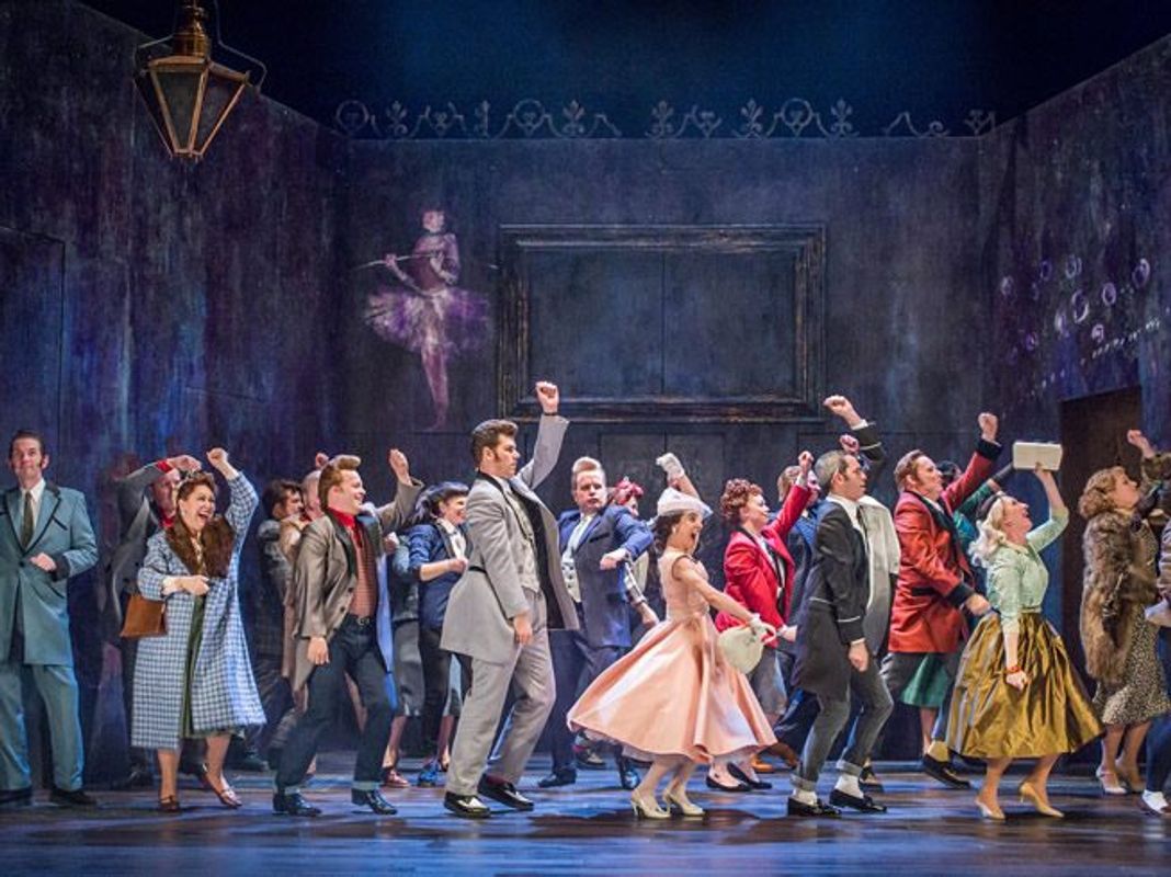 A room full of people in a party like setting all dancing together