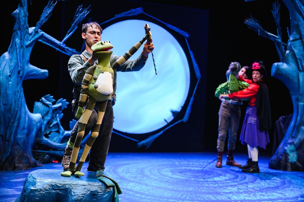 Two actors onstage holding animal puppets.