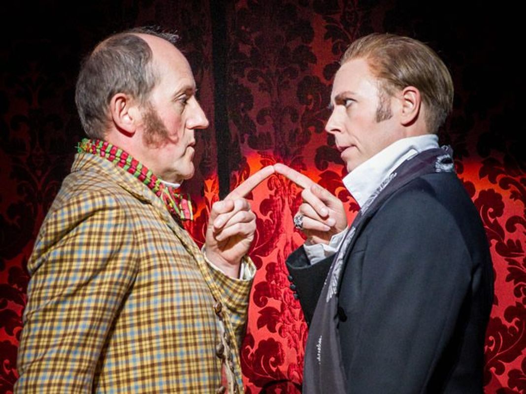 Two people are facing each other, they look to be in a disagreement. Their fingers are pointing at each other and touching