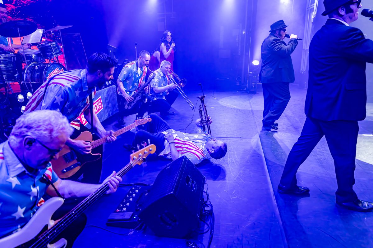 Multiple musicians play their instruments on stage.