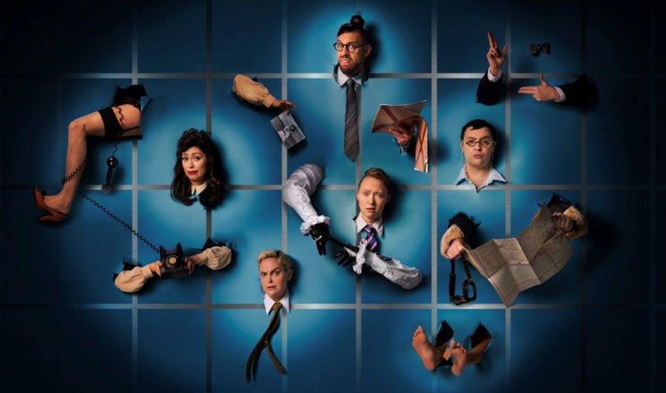 Surreal image of disjointed body parts with detached expressions, scattered across a blue grid. The scene is whimsical and eccentric.