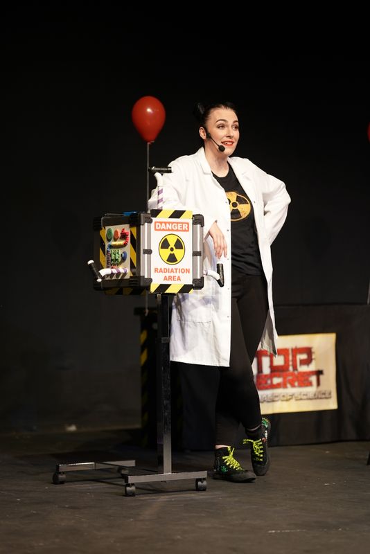 A person leans on a machine.