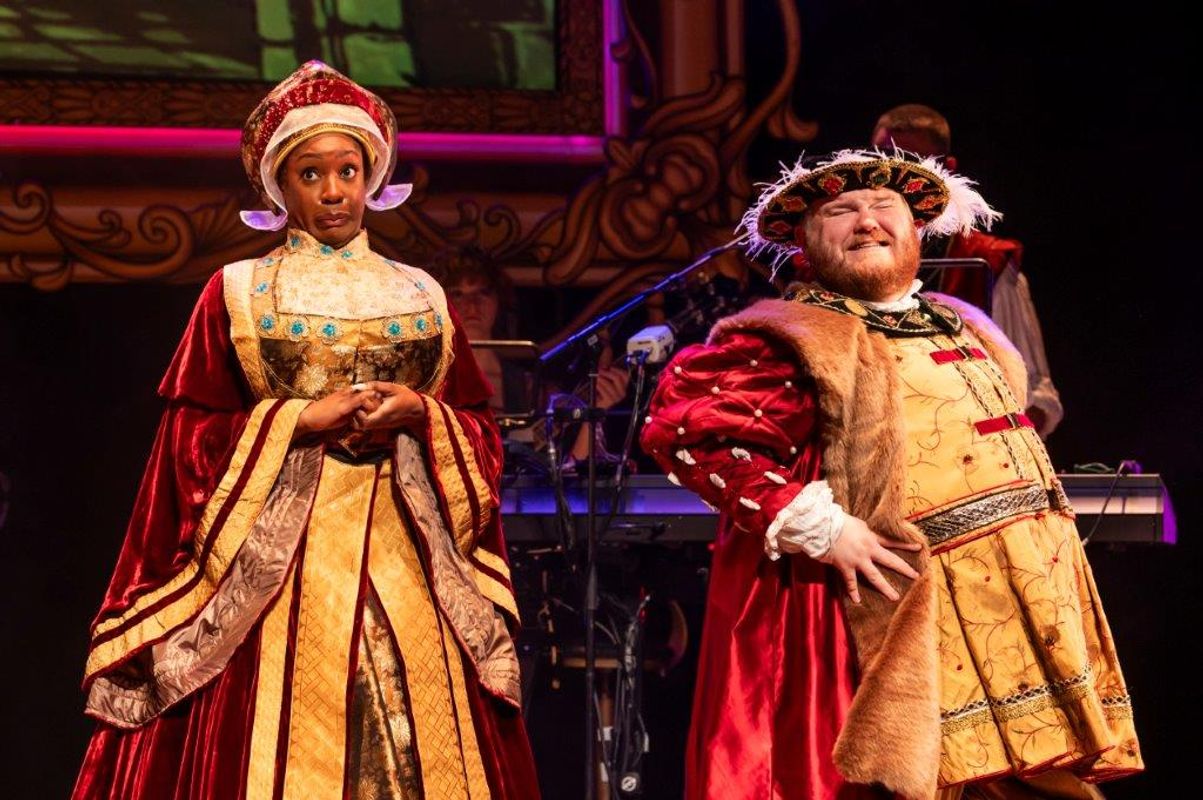 Two people dressed in tudor outfits