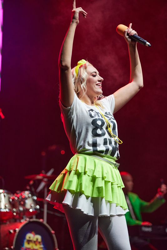 A person dressed in a a yellow tutu dances on stage.