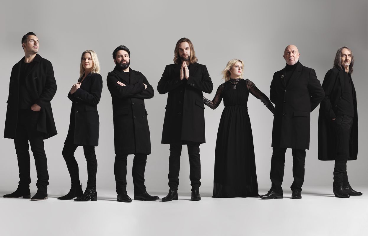 Seven people dressed in black stand next to each other.