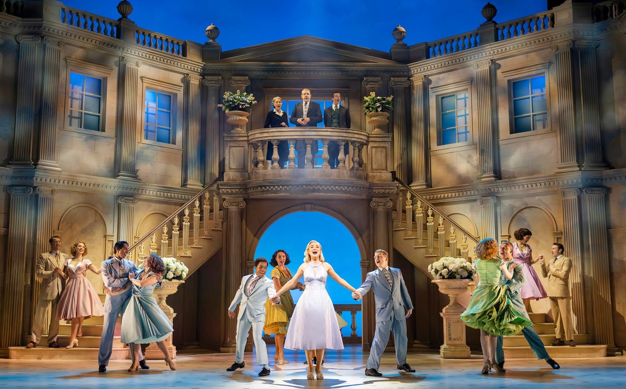 Cast members of High Society performing onstage.