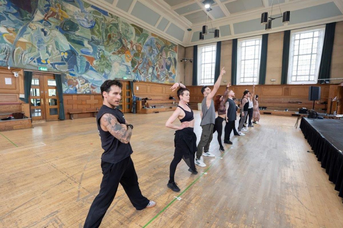 A group of dancers rehearsing in a dancing studio