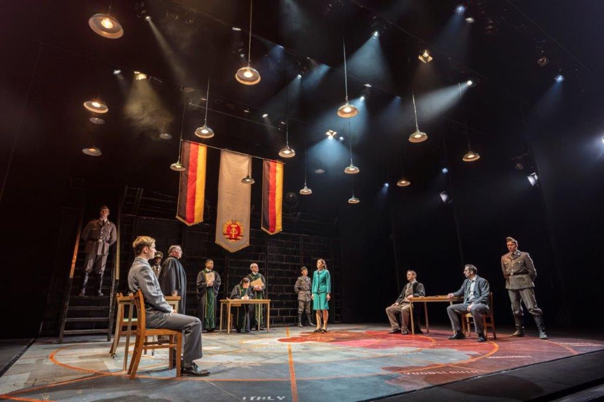 There is a group of people in a courtroom like setting