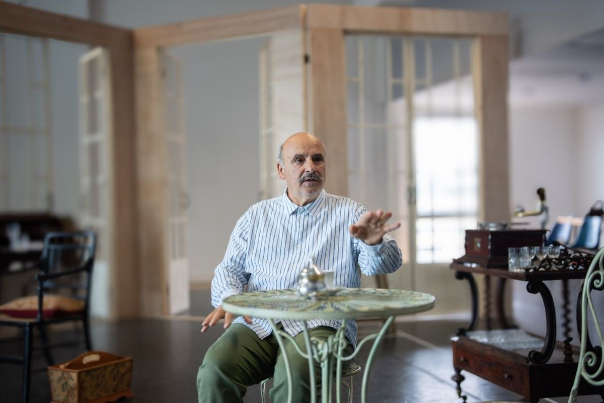 A man is sat at a little table by himself
