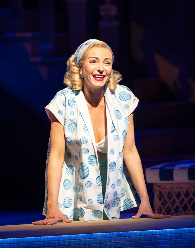 Helen George smiling on the stage set of High Society.
