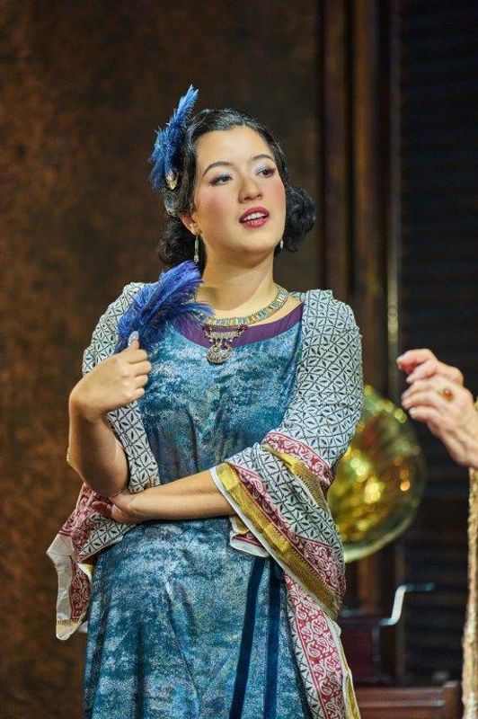 A person stood facing our and is wearing fancy clothing