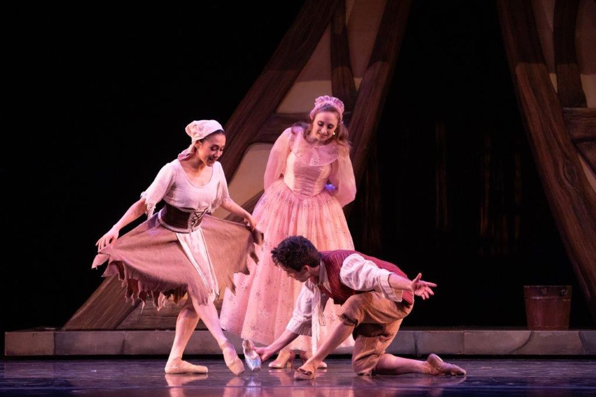 The Milwaukee Company dancing on stage for the production of Northern Ballet Cinderella. The are wearing Victorian styles costumes and are moving elegantly.