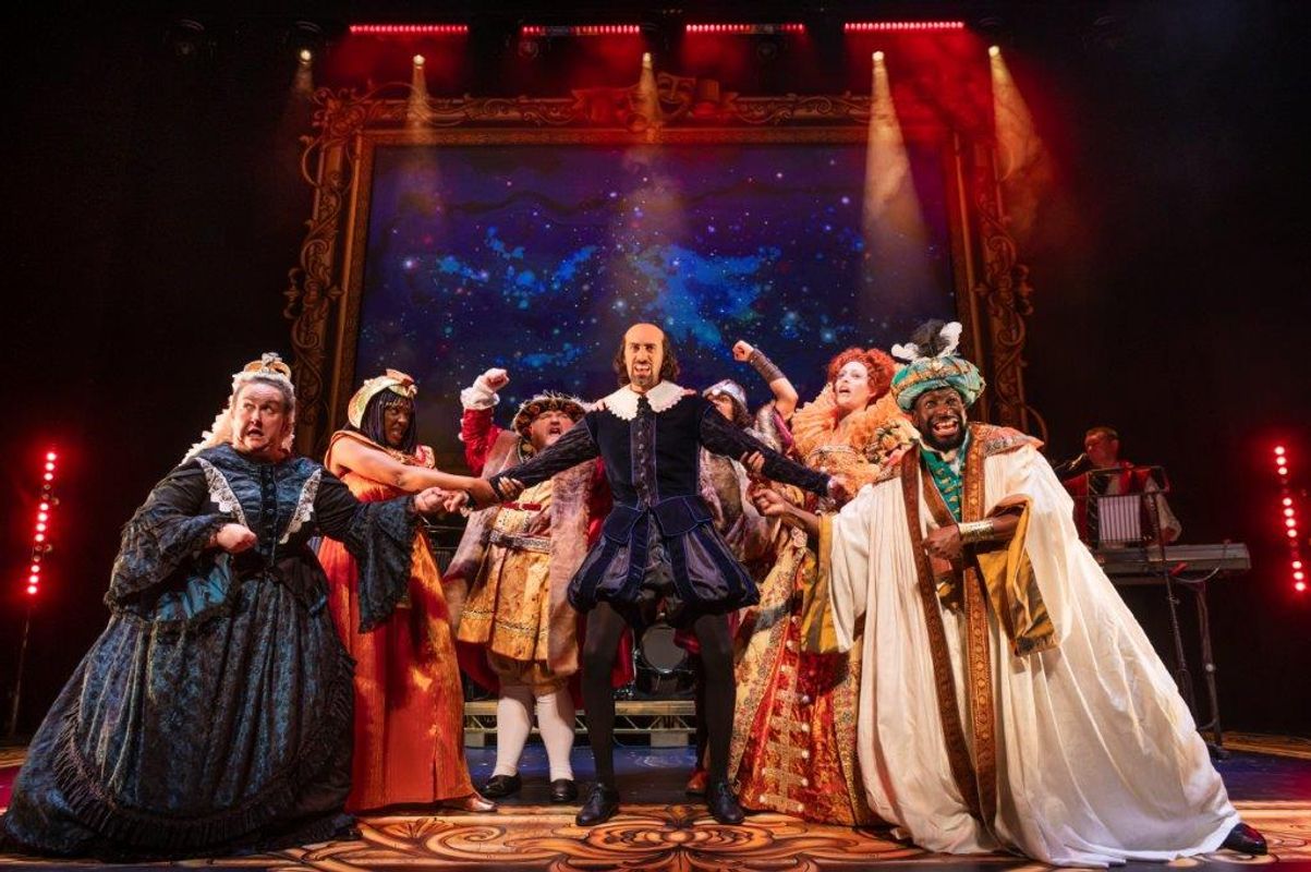 People on stage in historic clothes