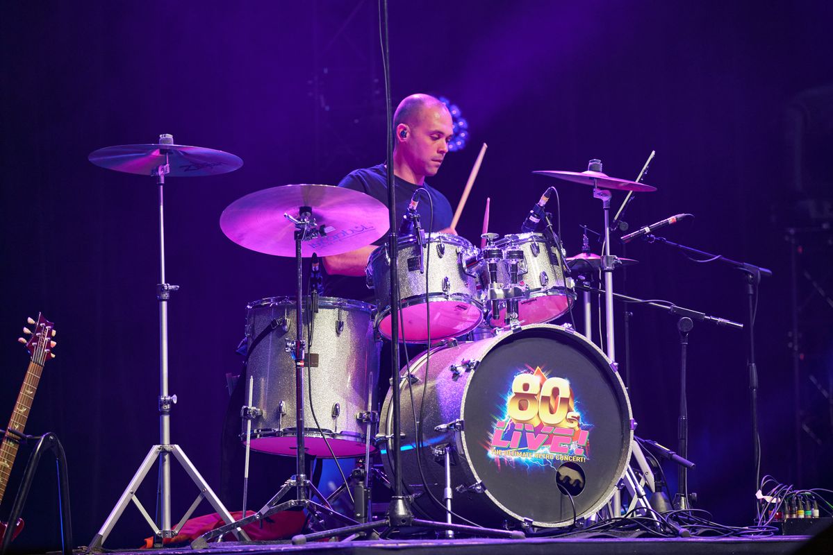 A person plays the drums.