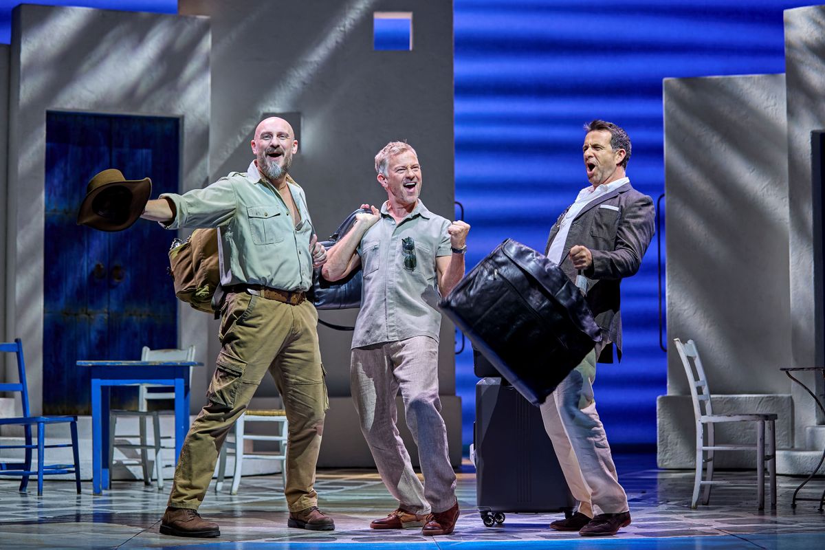 The three dads arrive holding their luggage.