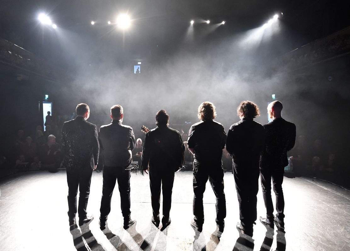 Six people look out to the audience.