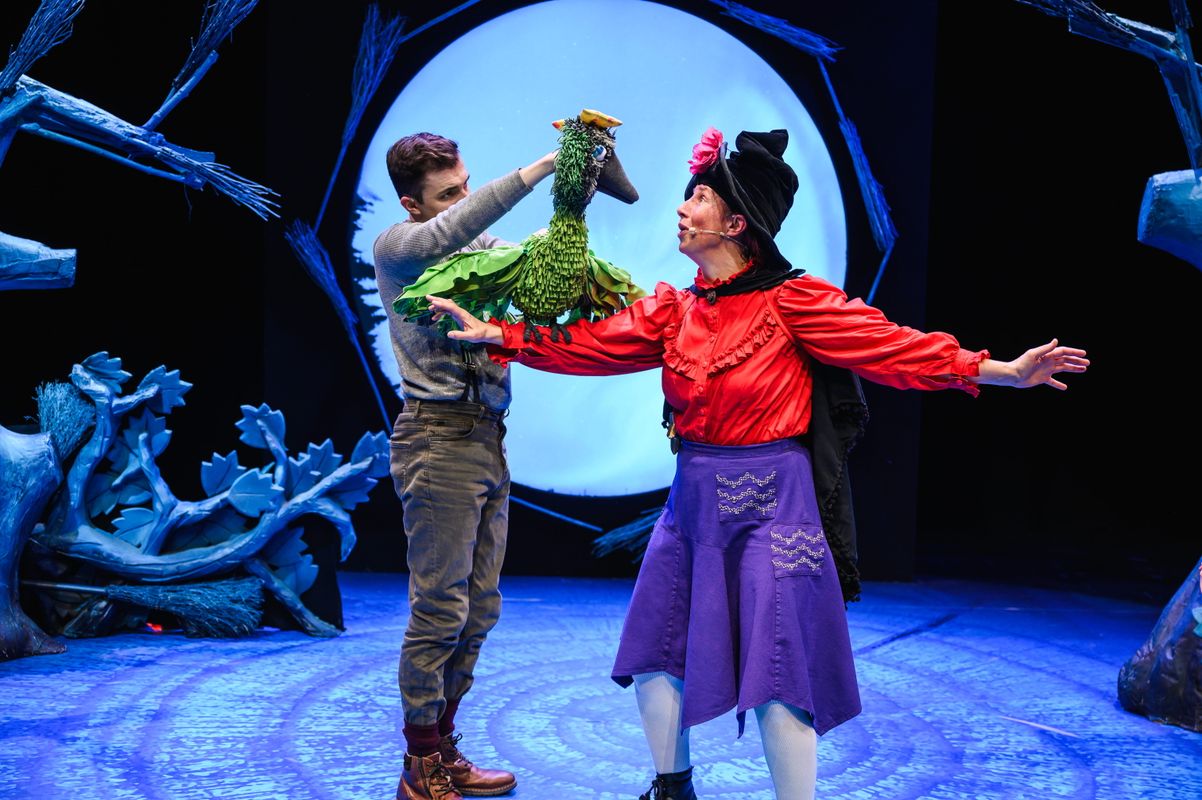 Two actors onstage with a bird puppet.