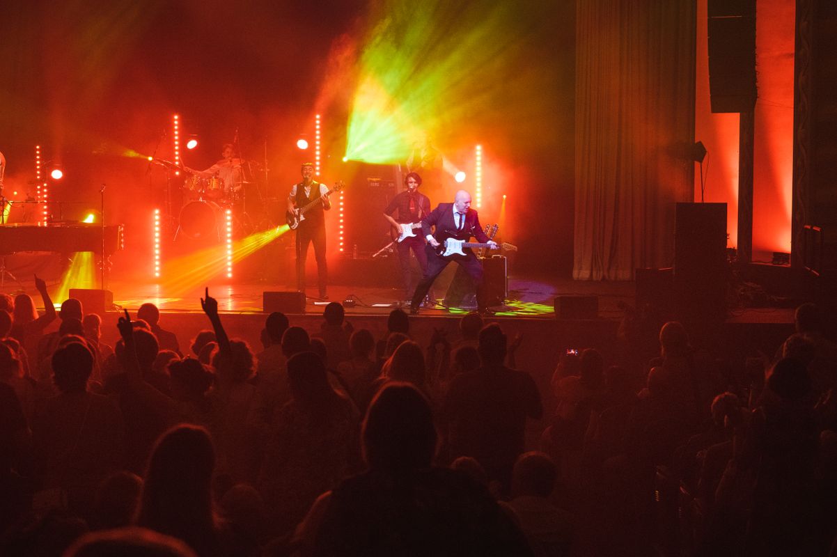The audience watch the band playing.
