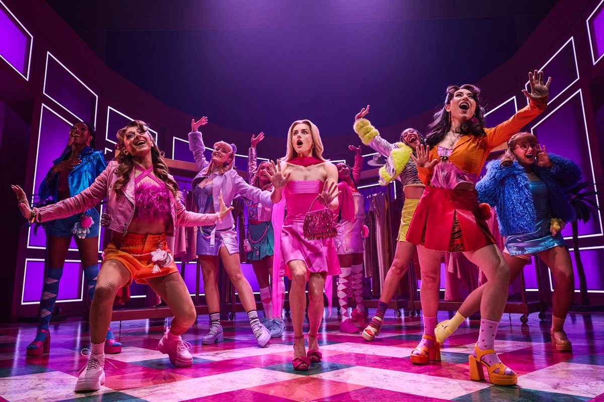 The cast of Legally Blonde on stage wearing  bright outfits.