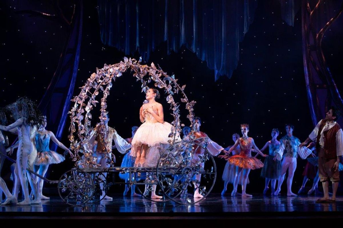 The Milwaukee Company dancing on stage for the production of Northern Ballet Cinderella. The are wearing Victorian styles costumes and are moving elegantly.