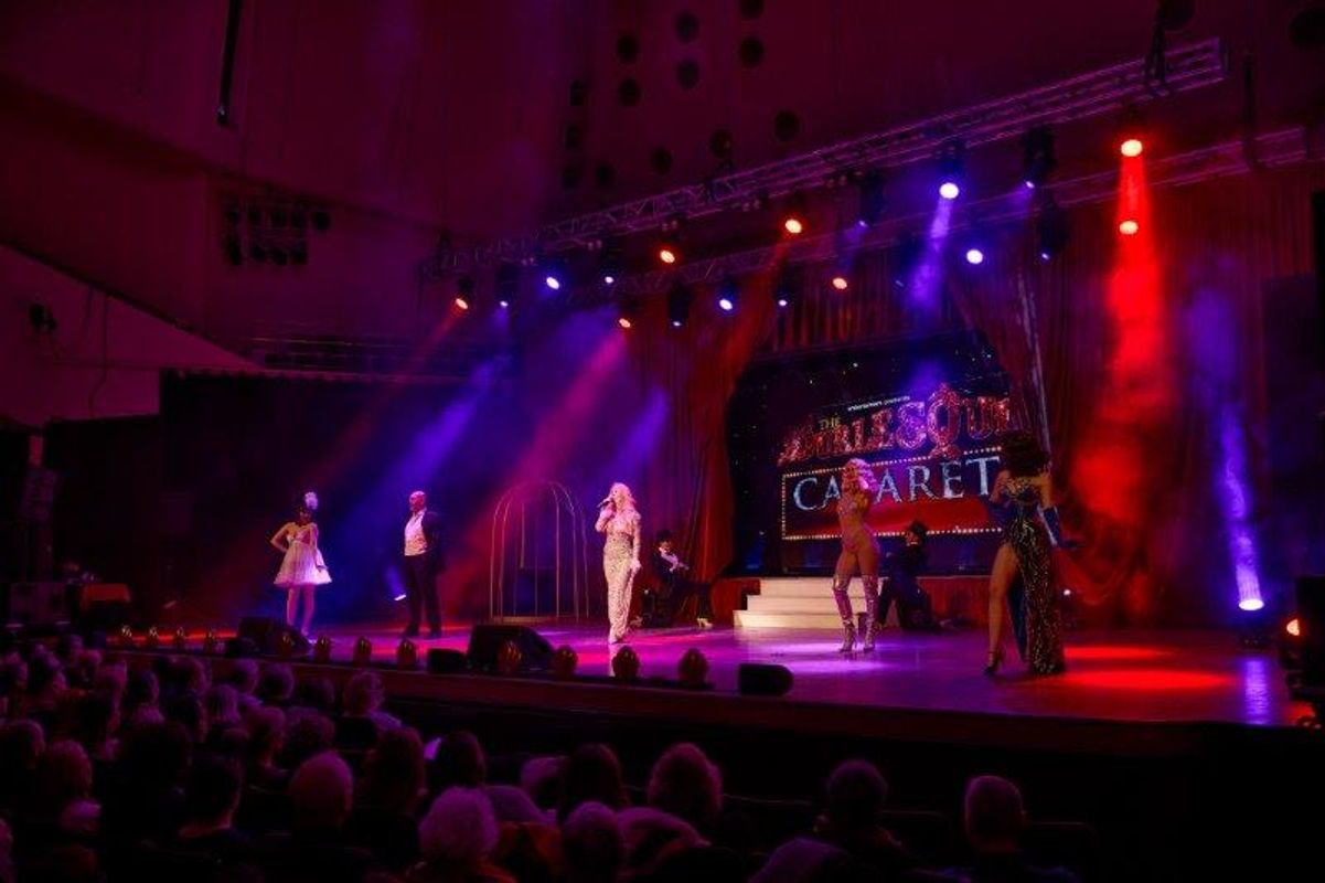 An audience watches performers on stage.