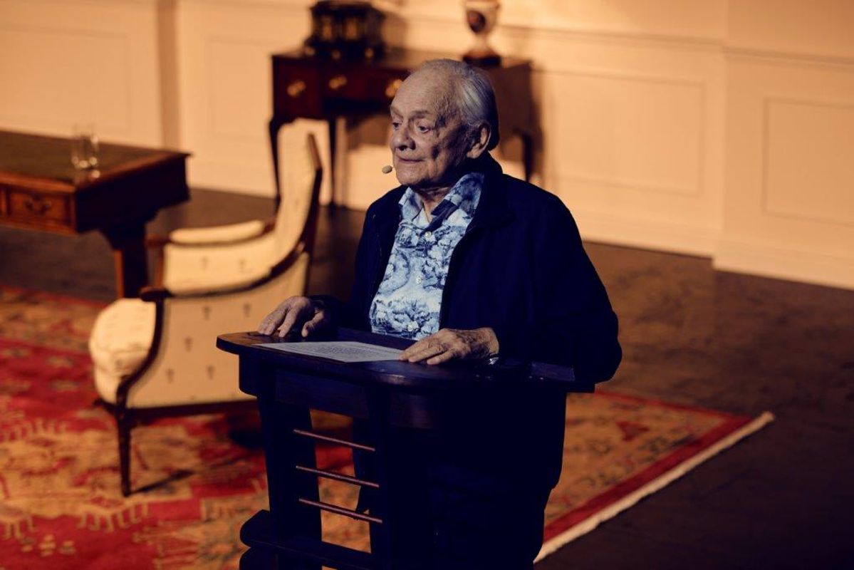 Sir David Jason is stood at a podium