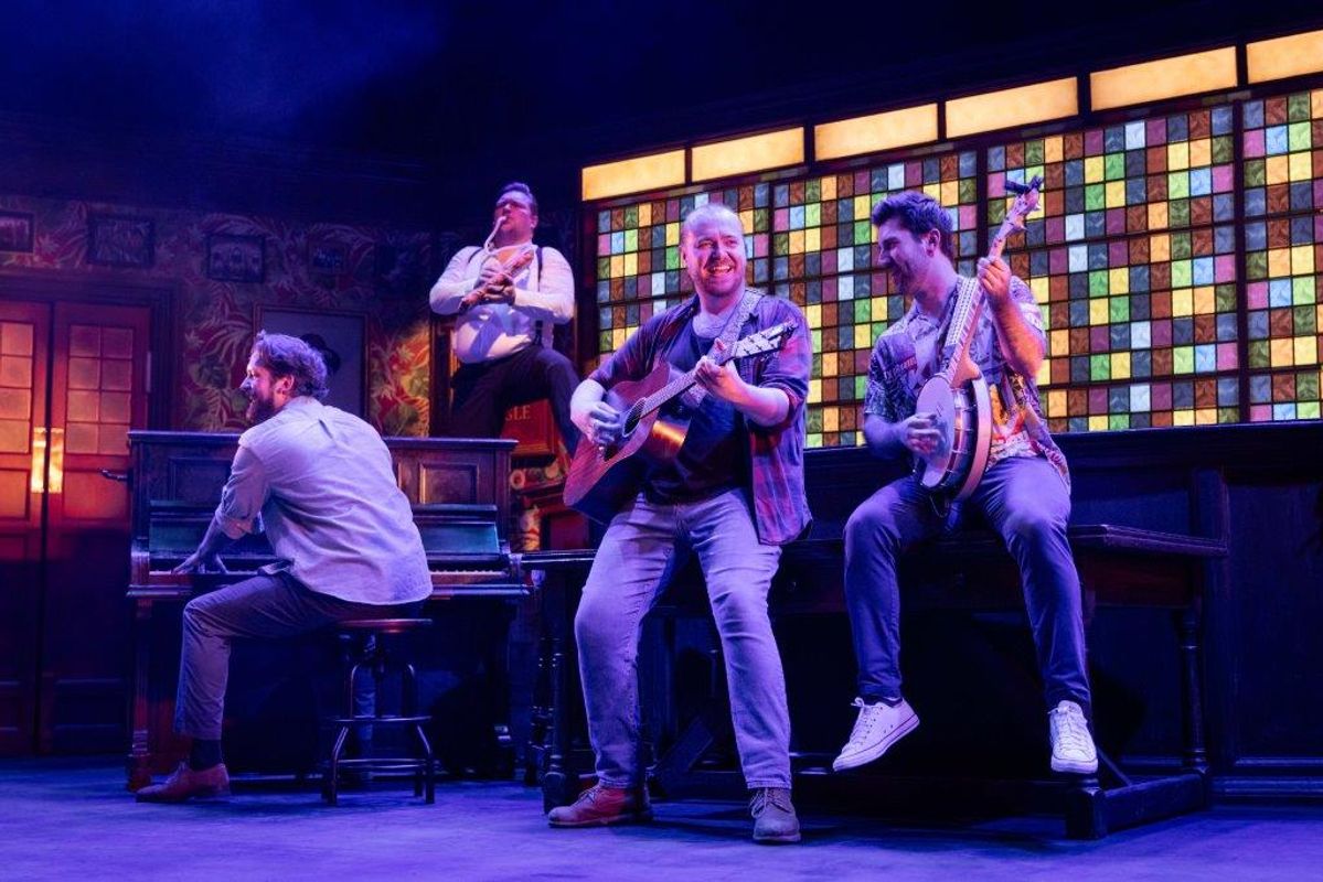 There  are four people playing instruments. One is on a piano, another with a guitar, one is playing a banjo and the last is  blowing into a  instrument