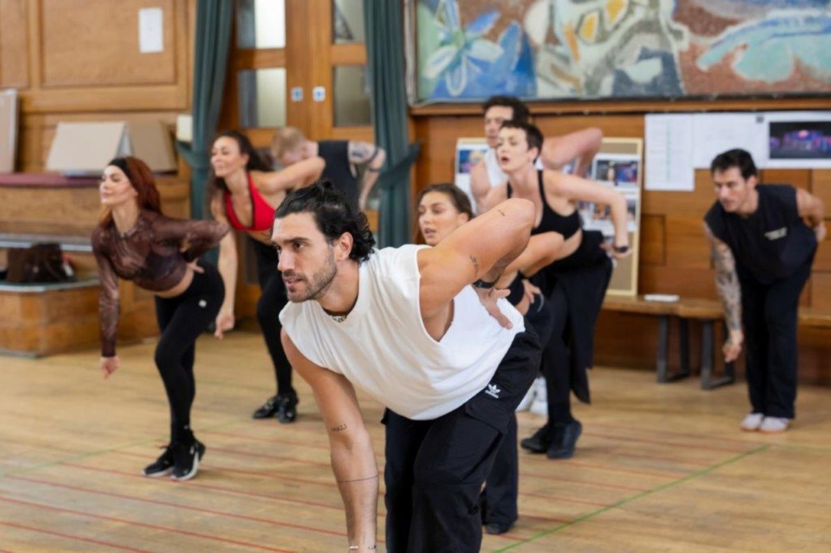A group of dancers rehearsing in a dancing studio
