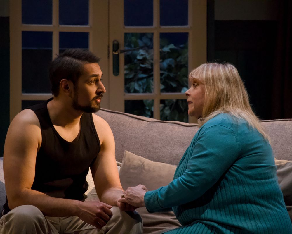 Two people sat on the sofa talking