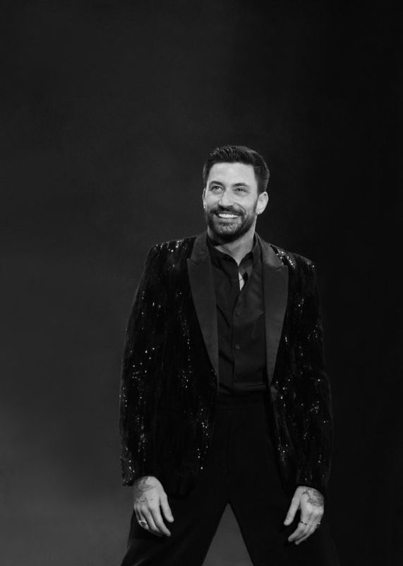 A black and white image of Giovanni smiling