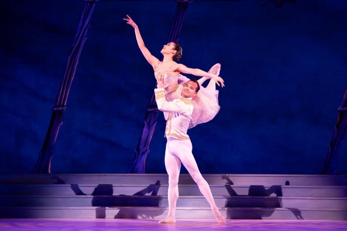 The Milwaukee Company dancing on stage for the production of Northern Ballet Cinderella. The are wearing Victorian styles costumes and are moving elegantly.