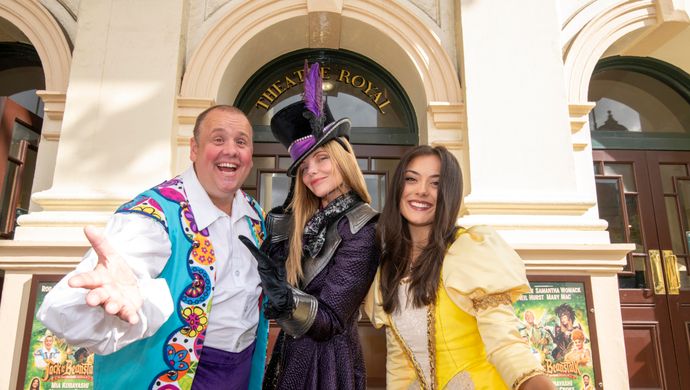 Three actors pose in character outside the Theatre Royal.