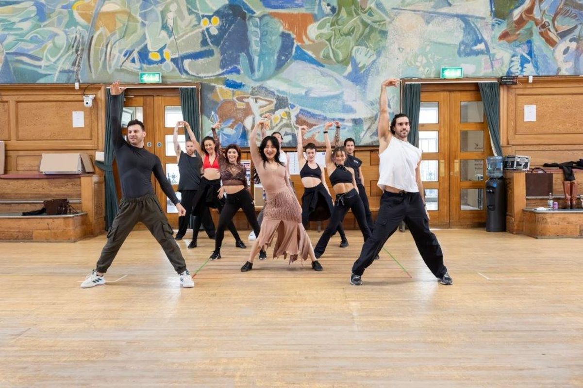 A group of dancers rehearsing in a dancing studio