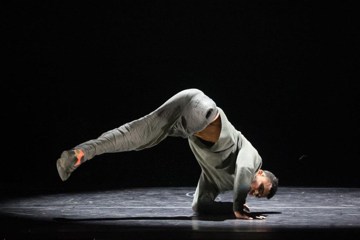 An amputee is captured mid breakdance using both arms to balance.