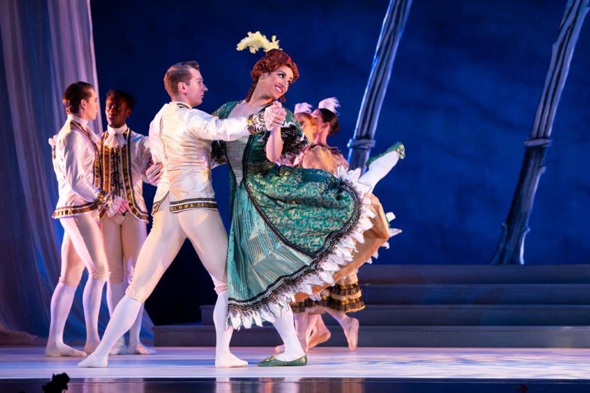 The Milwaukee Company dancing on stage for the production of Northern Ballet Cinderella. The are wearing Victorian styles costumes and are moving elegantly.