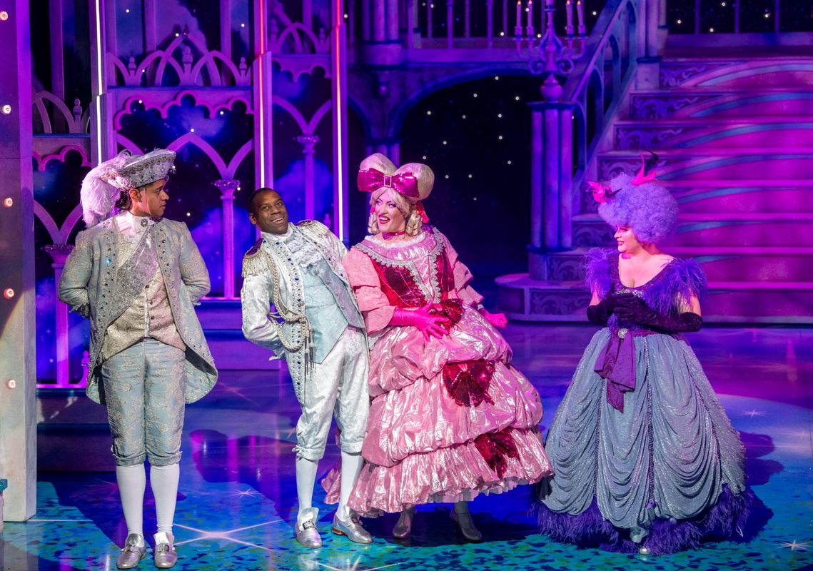 Prince Charming and Dandini dressed in their white outfits back away from the Wicked Stepsisters.