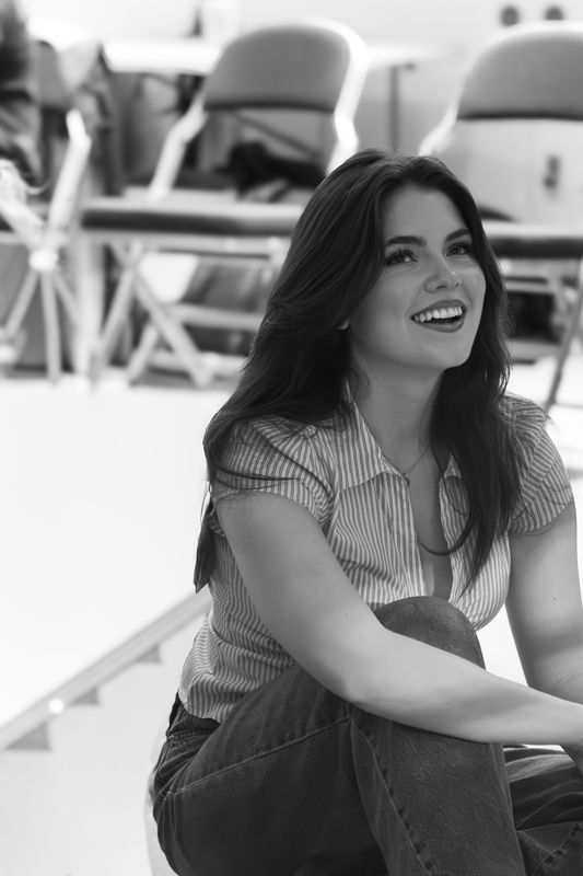 A young woman sat smiling