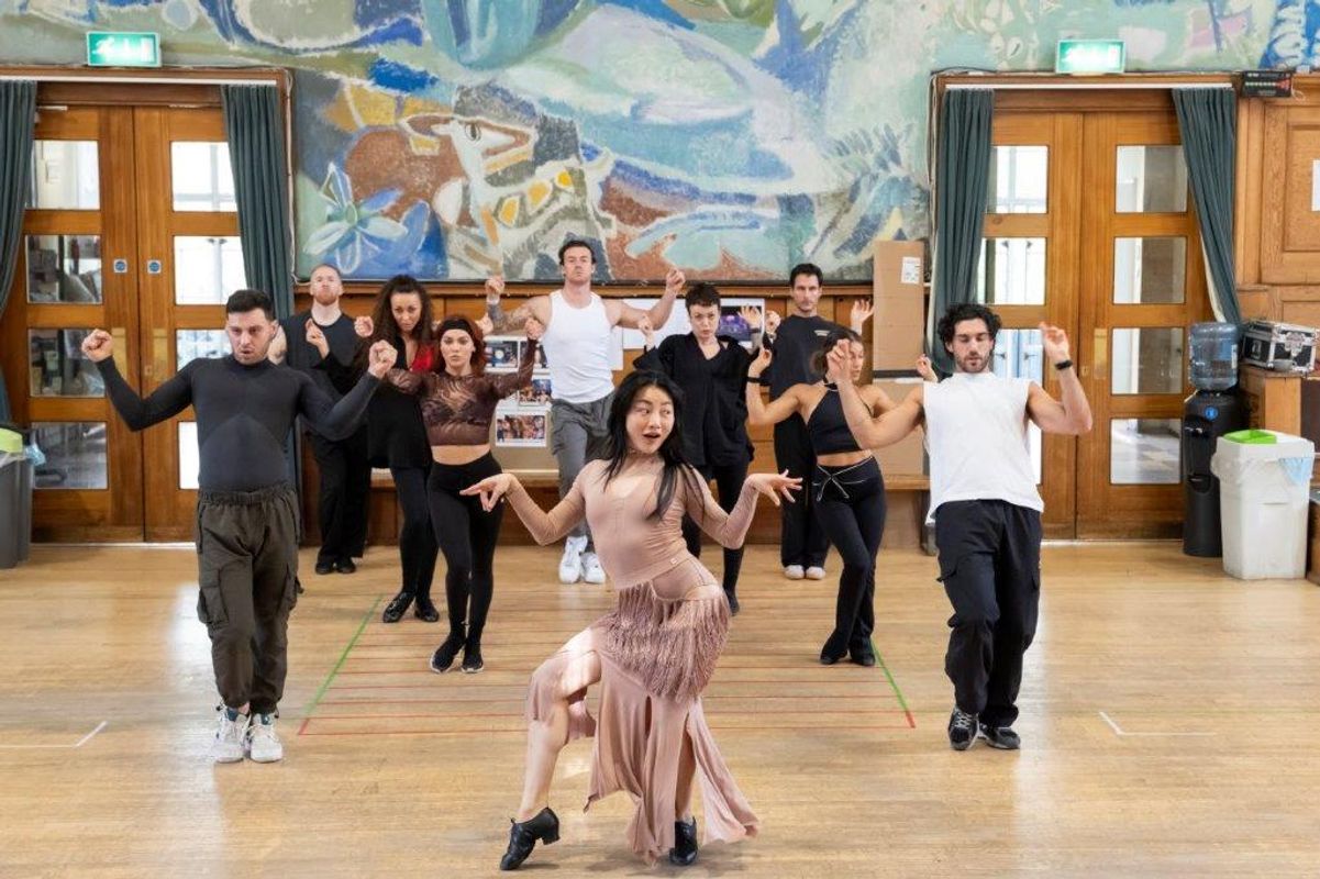 A group of dancers rehearsing in a dancing studio