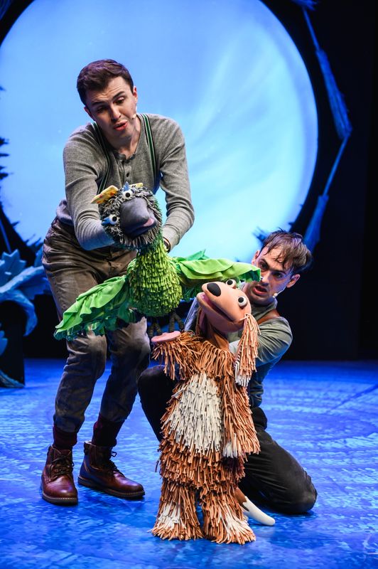 Two actors onstage with bird puppet