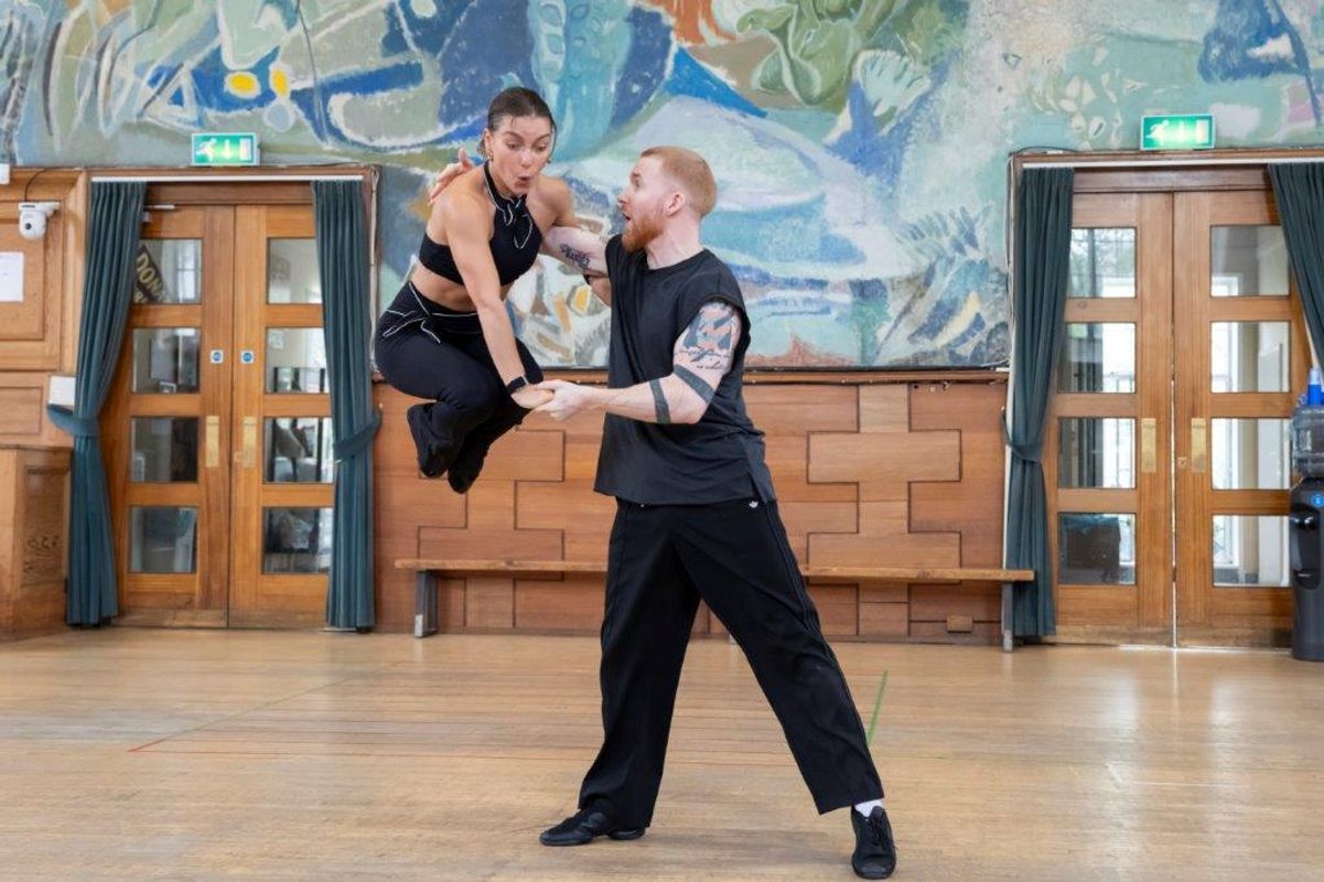 A group of dancers rehearsing in a dancing studio