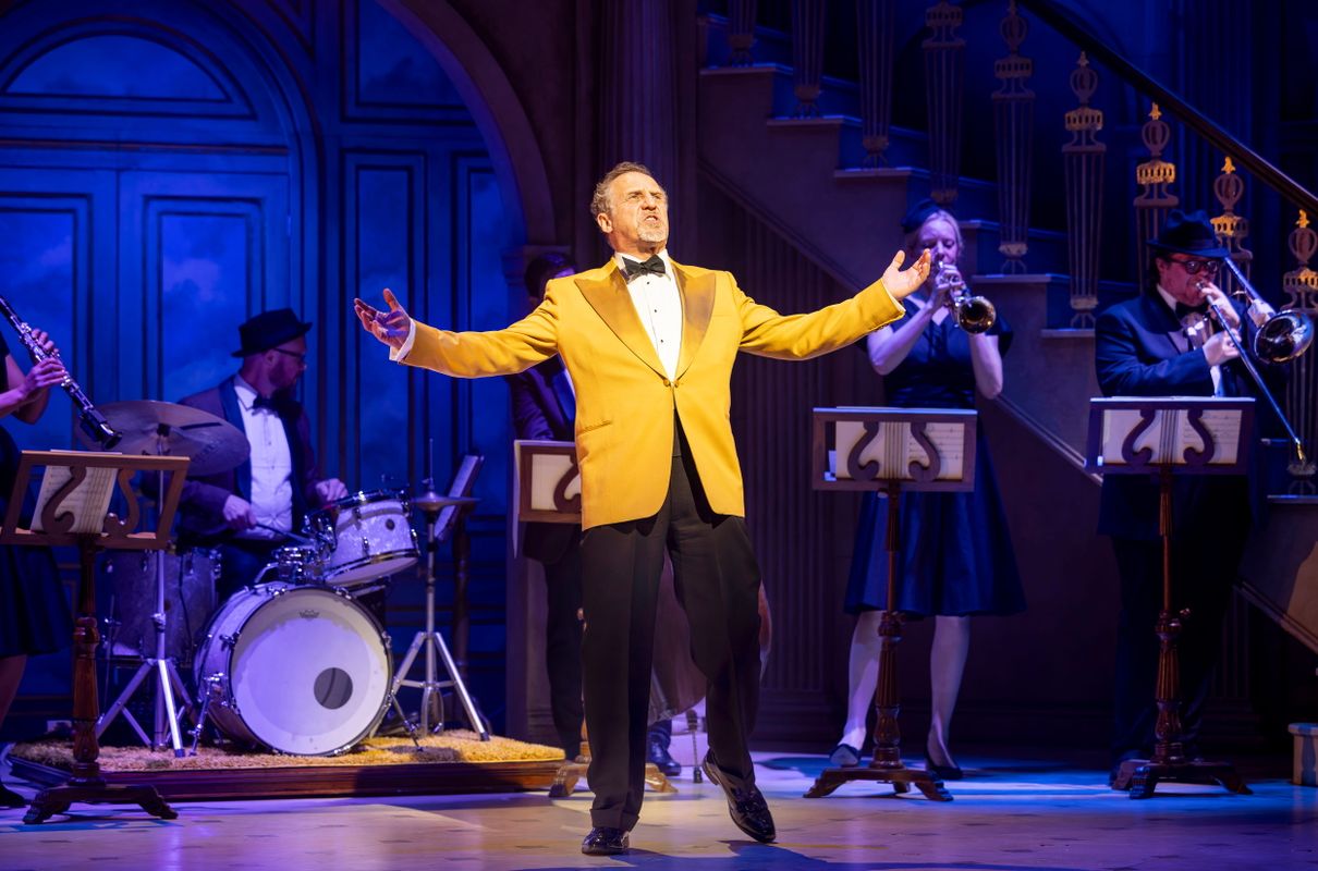 Cast member and musicians on the stage set of High Society.