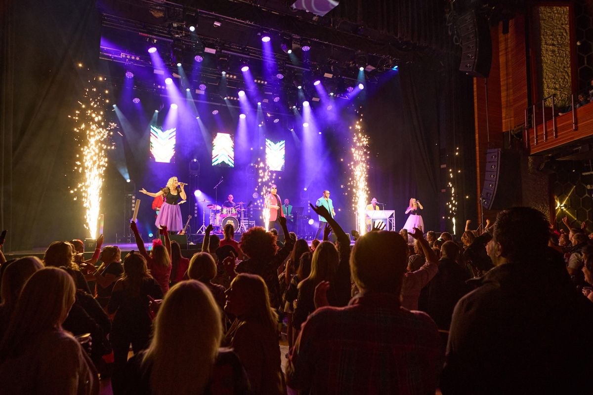 An audience dances along to the show.