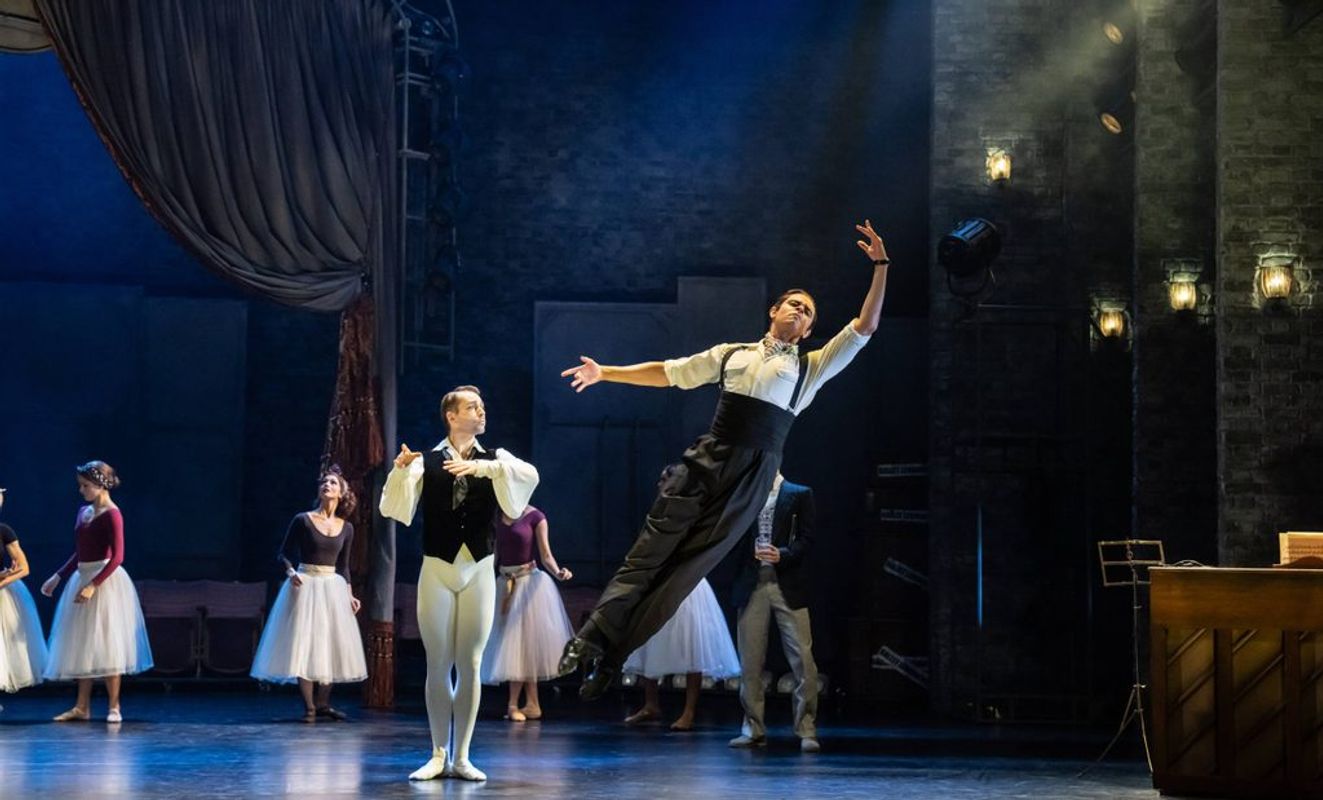 A dancer leaps to their left.