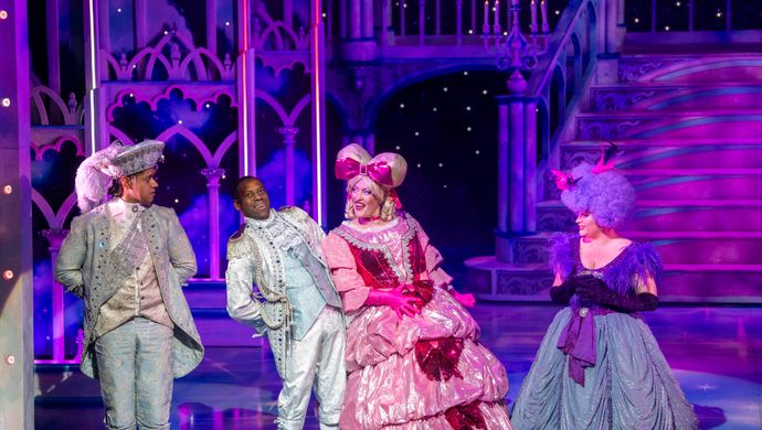 Prince Charming and Dandini dressed in their white outfits back away from the Wicked Stepsisters.