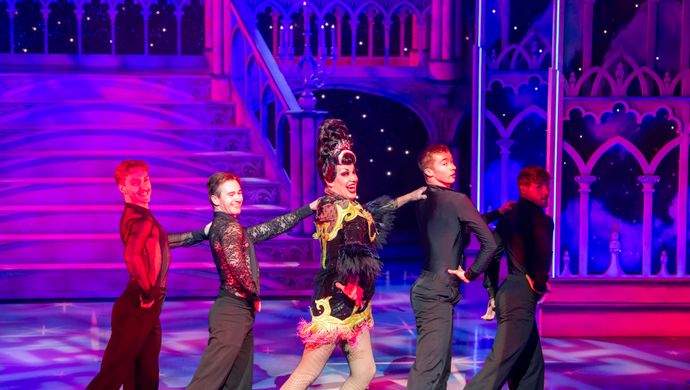 The Wicked stepmother stand in a line surrounded by 4 ensemble members looking over their right shoulders.