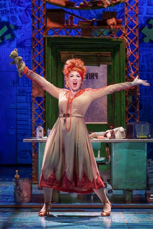 A woman with her arms open wide and she is performing and singing