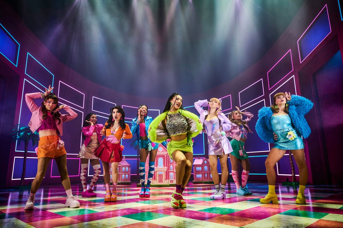 Group of Legally Blonde cast posing on stage in bright outfits.