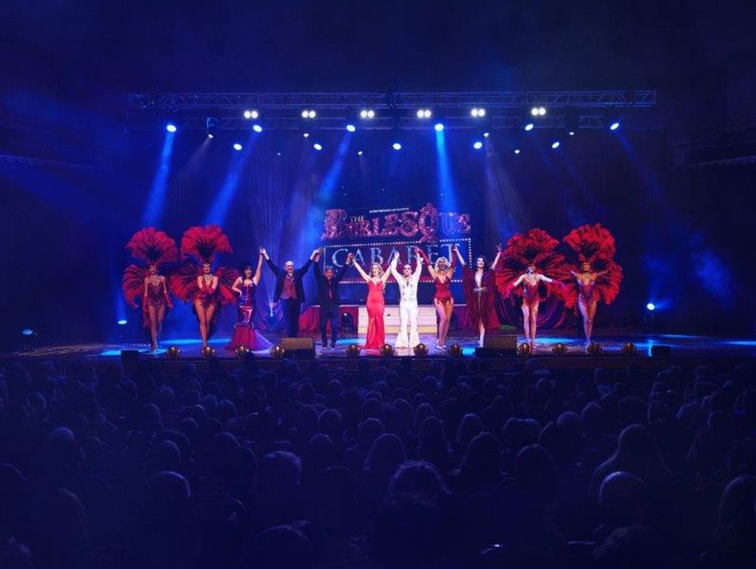 The company hold their hands high in the air.